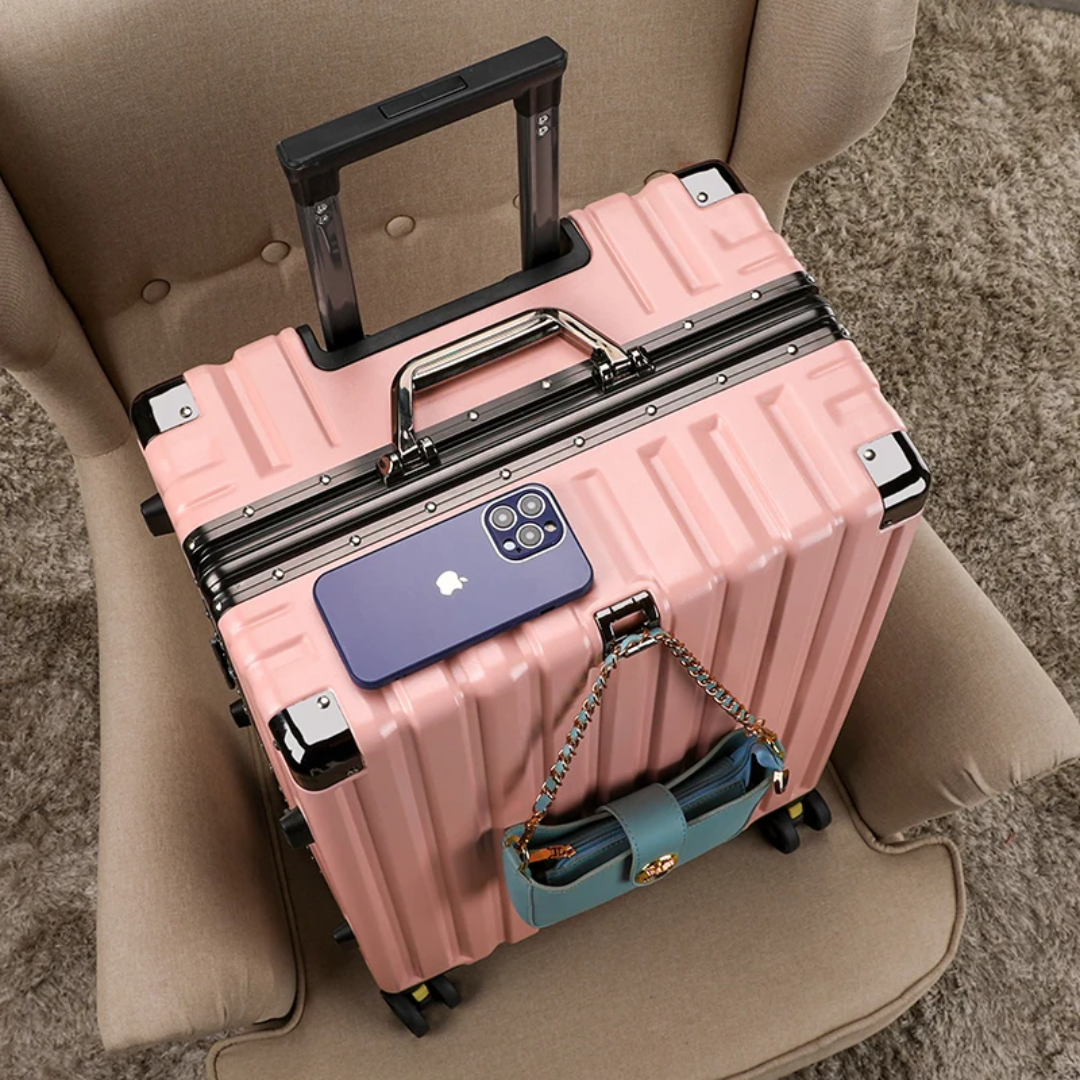 a pink piece of luggage sitting on top of a chair