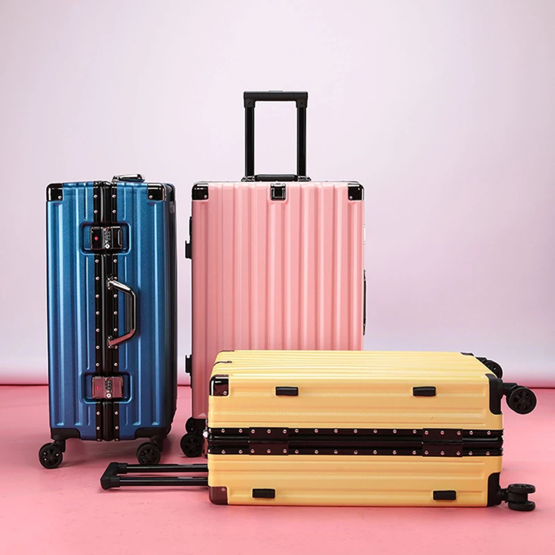 a group of three suitcases sitting on top of a pink floor