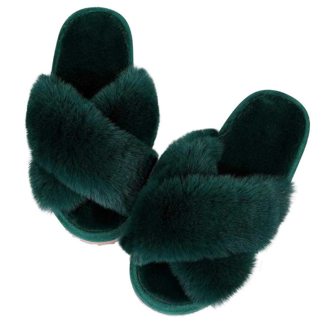 a pair of green furry slippers on a white background