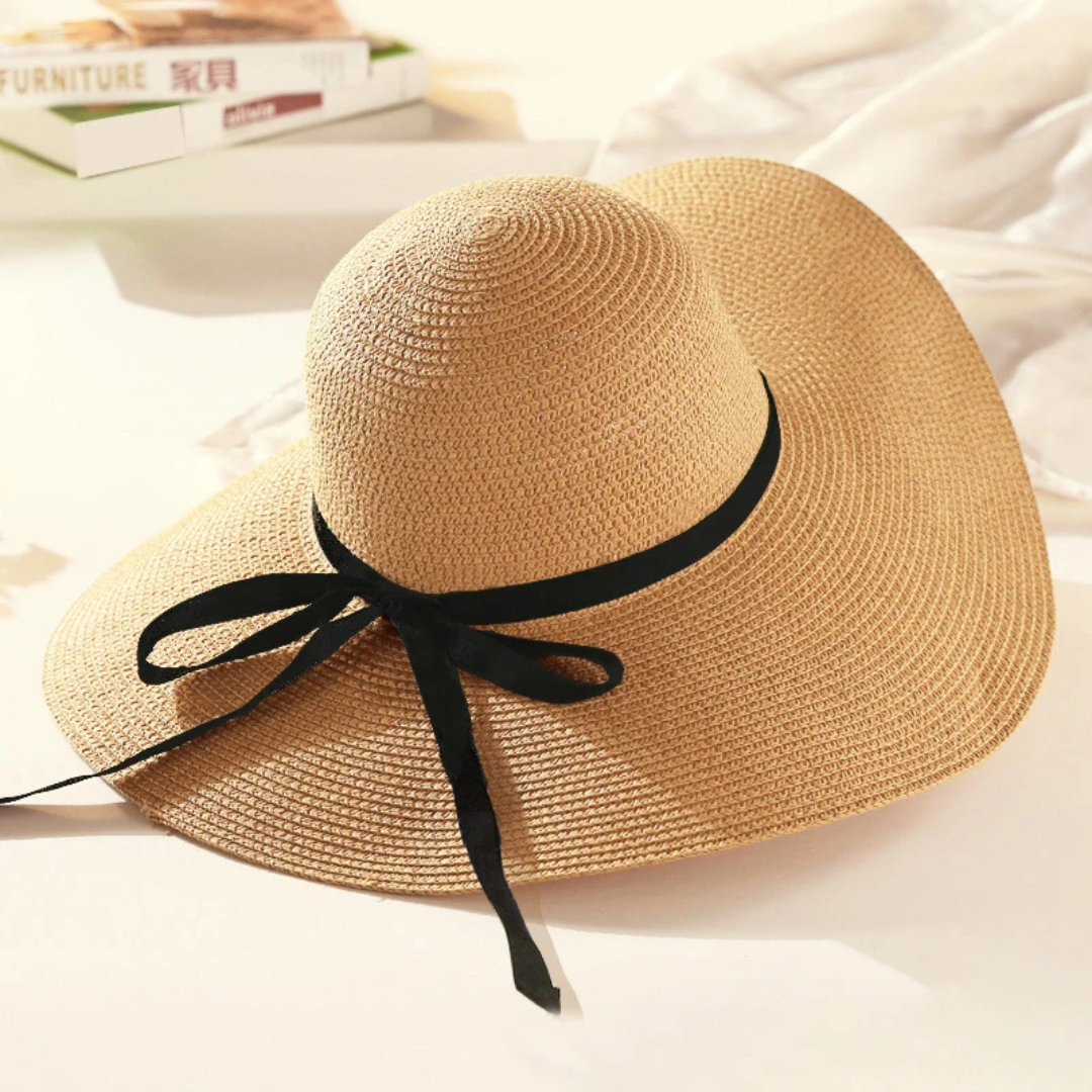 a straw hat with a black ribbon tied around the brim