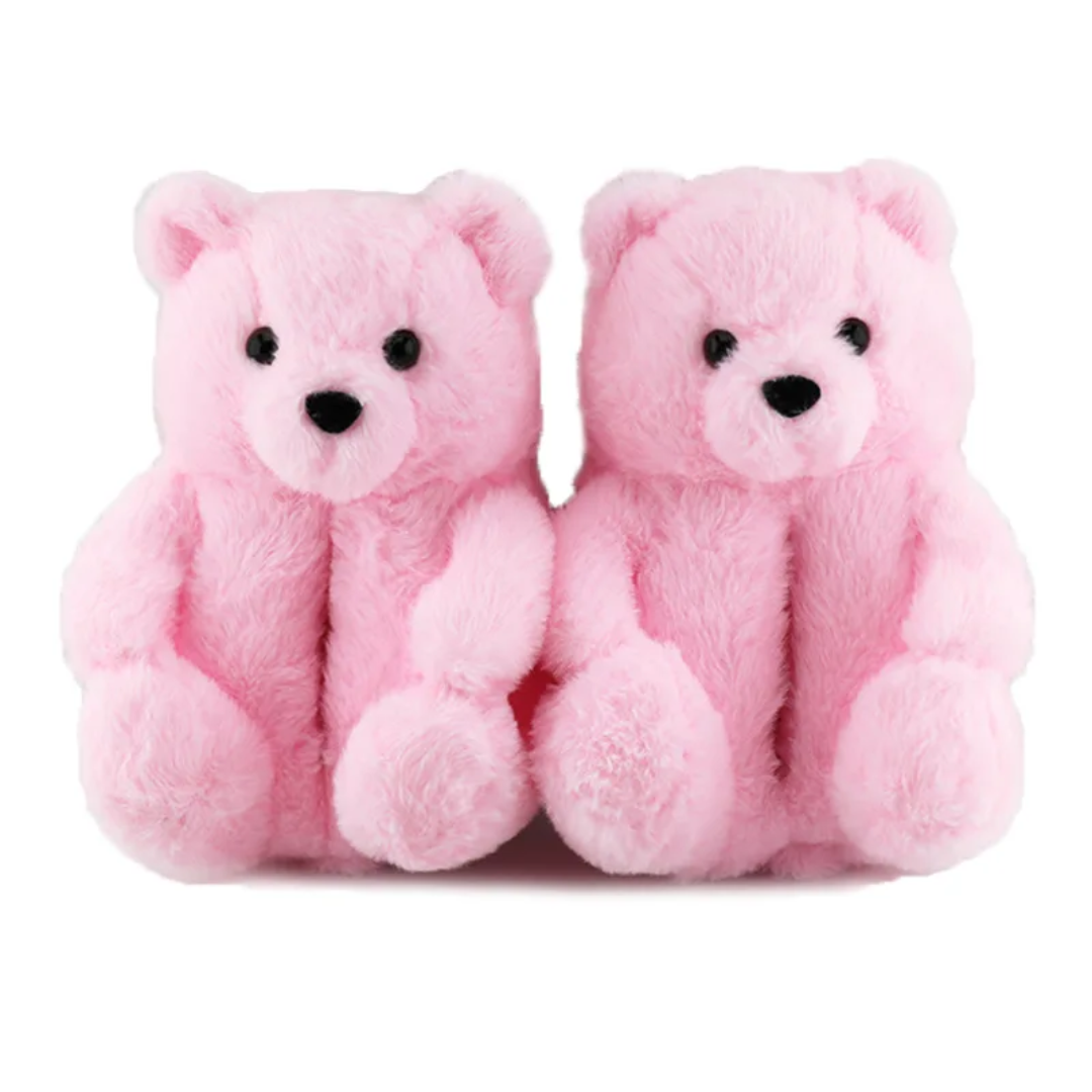 a pair of pink teddy bears sitting next to each other