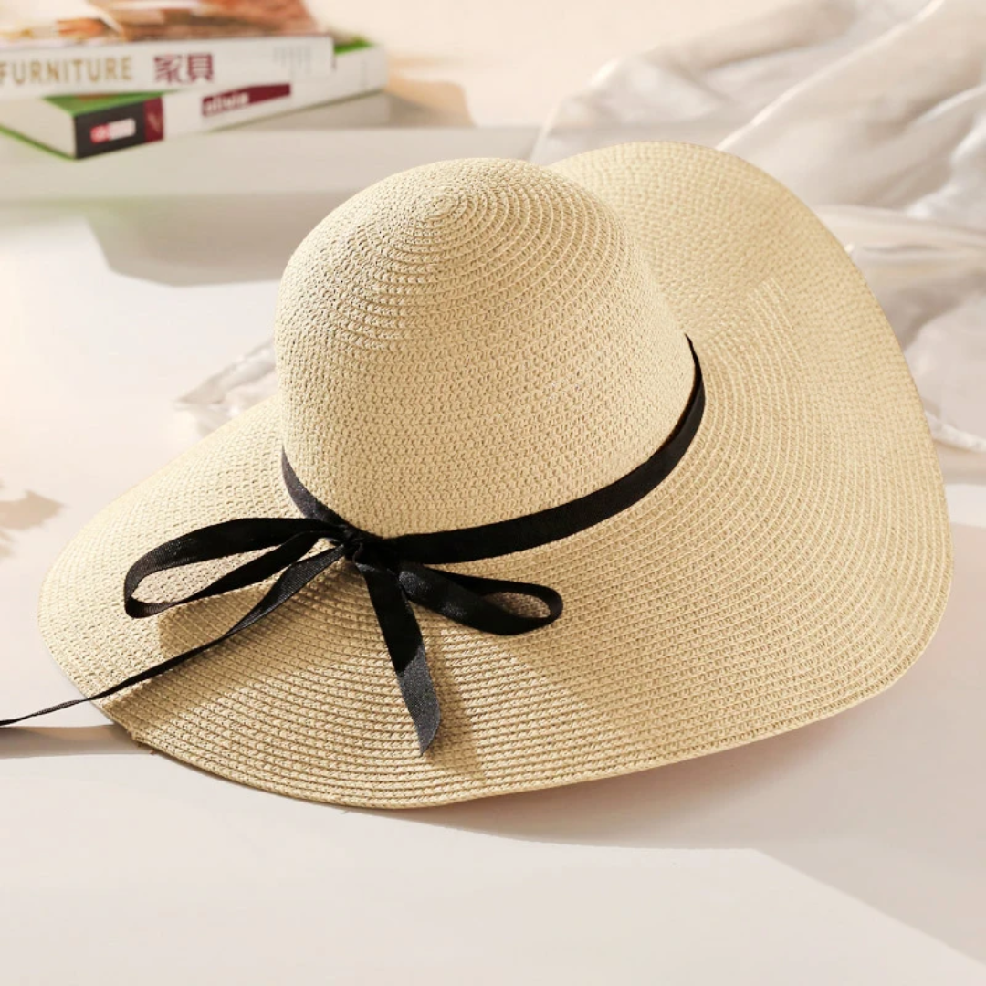 a straw hat with a black ribbon tied around the brim