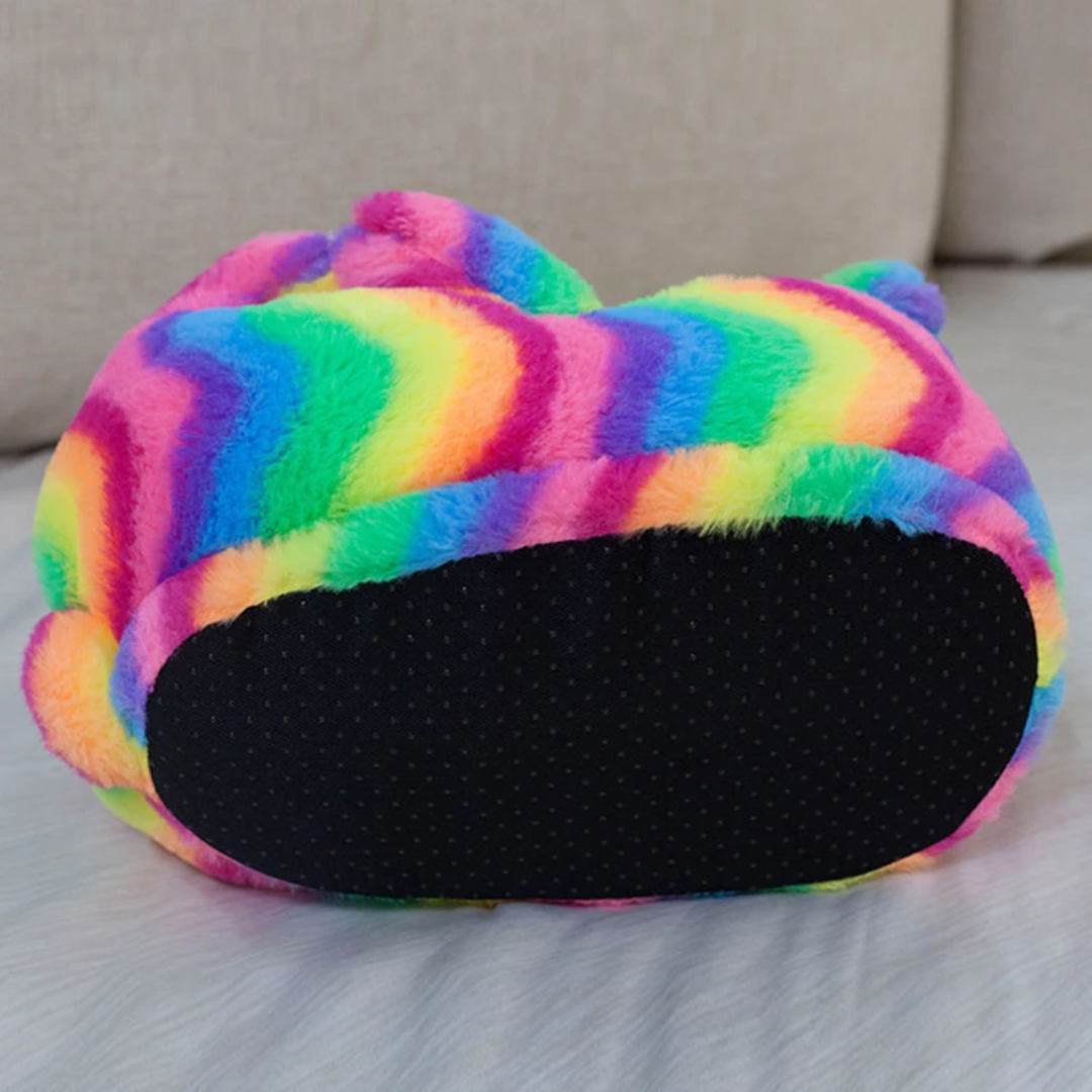a multicolored pillow sitting on top of a bed