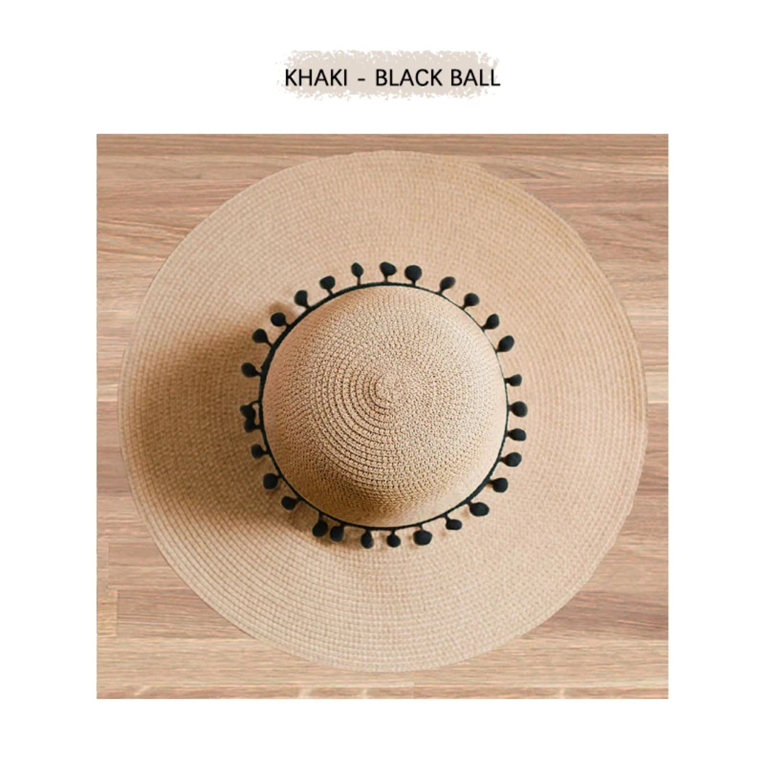 a hat with a black ball on top of it