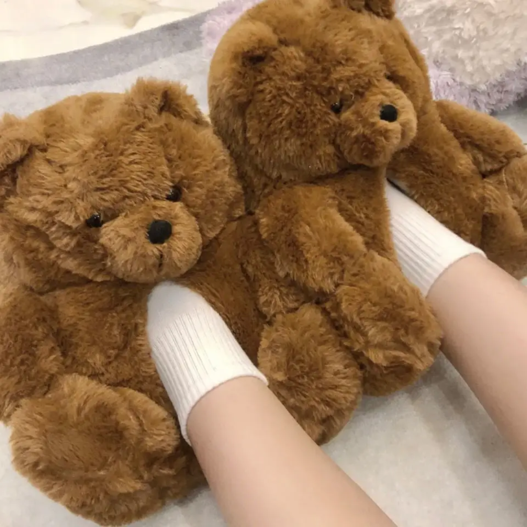 two teddy bears are being held by a woman