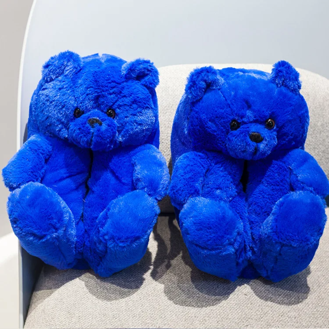 two blue teddy bears sitting on a chair