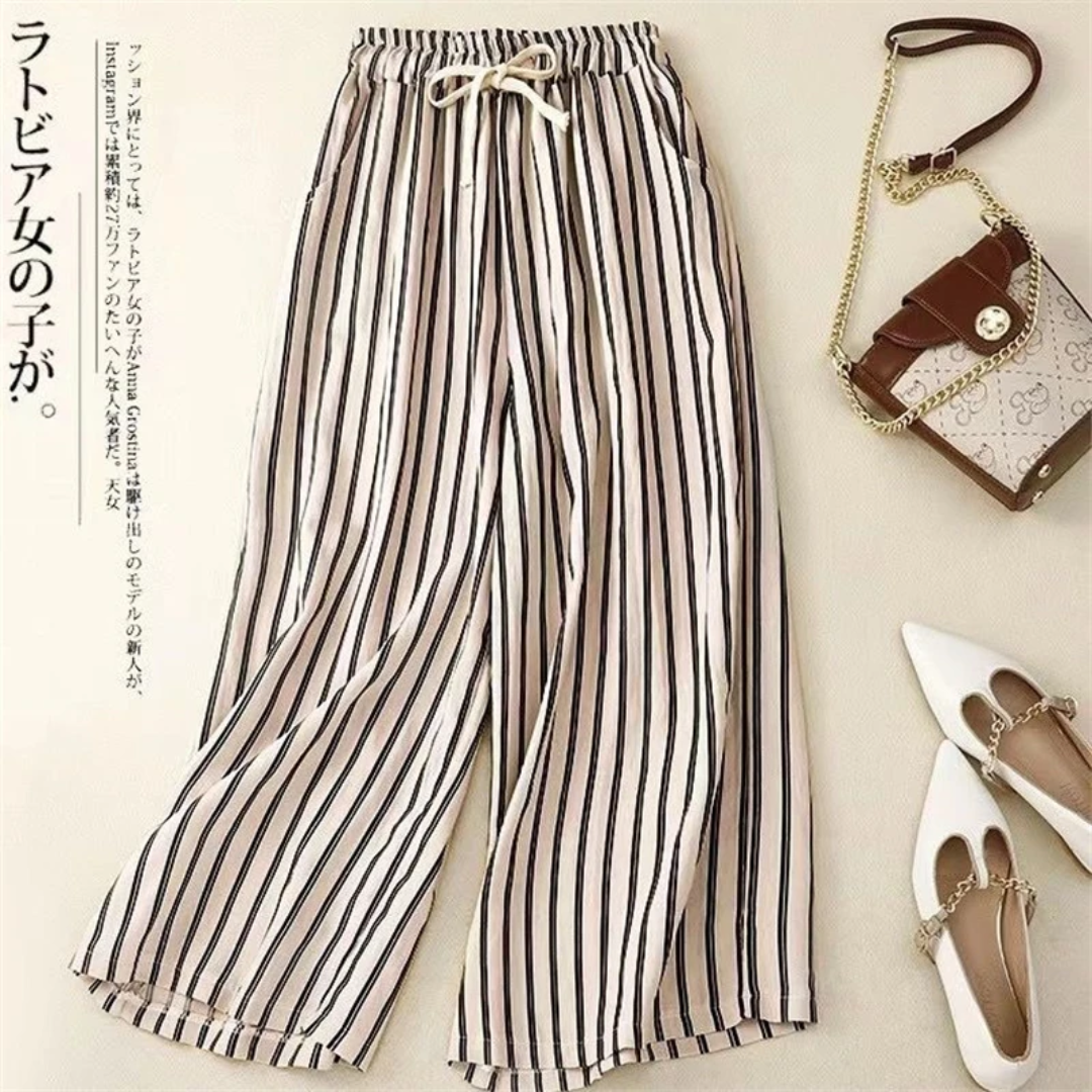 a pair of striped pants and a handbag next to a purse