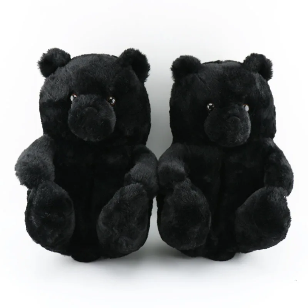 two black teddy bears sitting next to each other