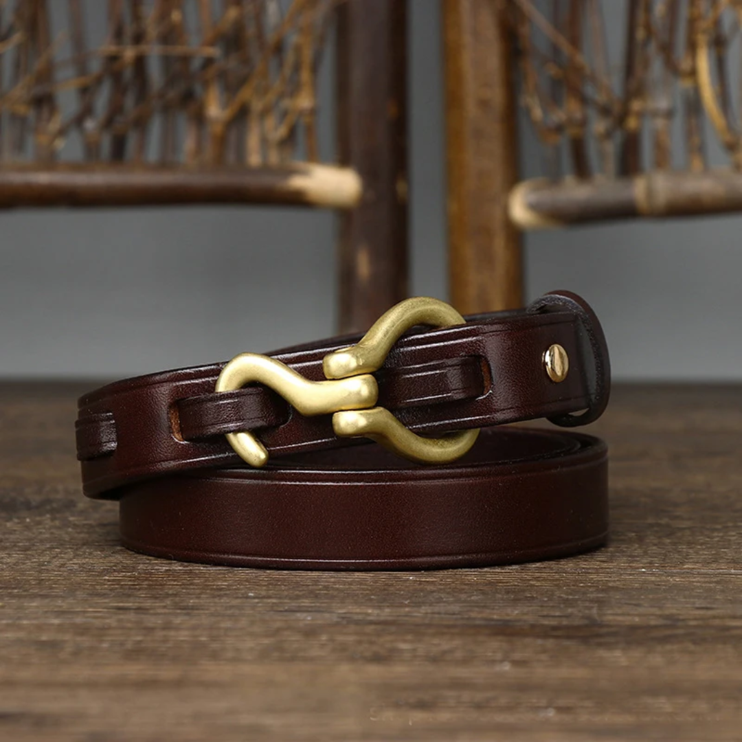 a close up of a brown leather belt on a wooden table