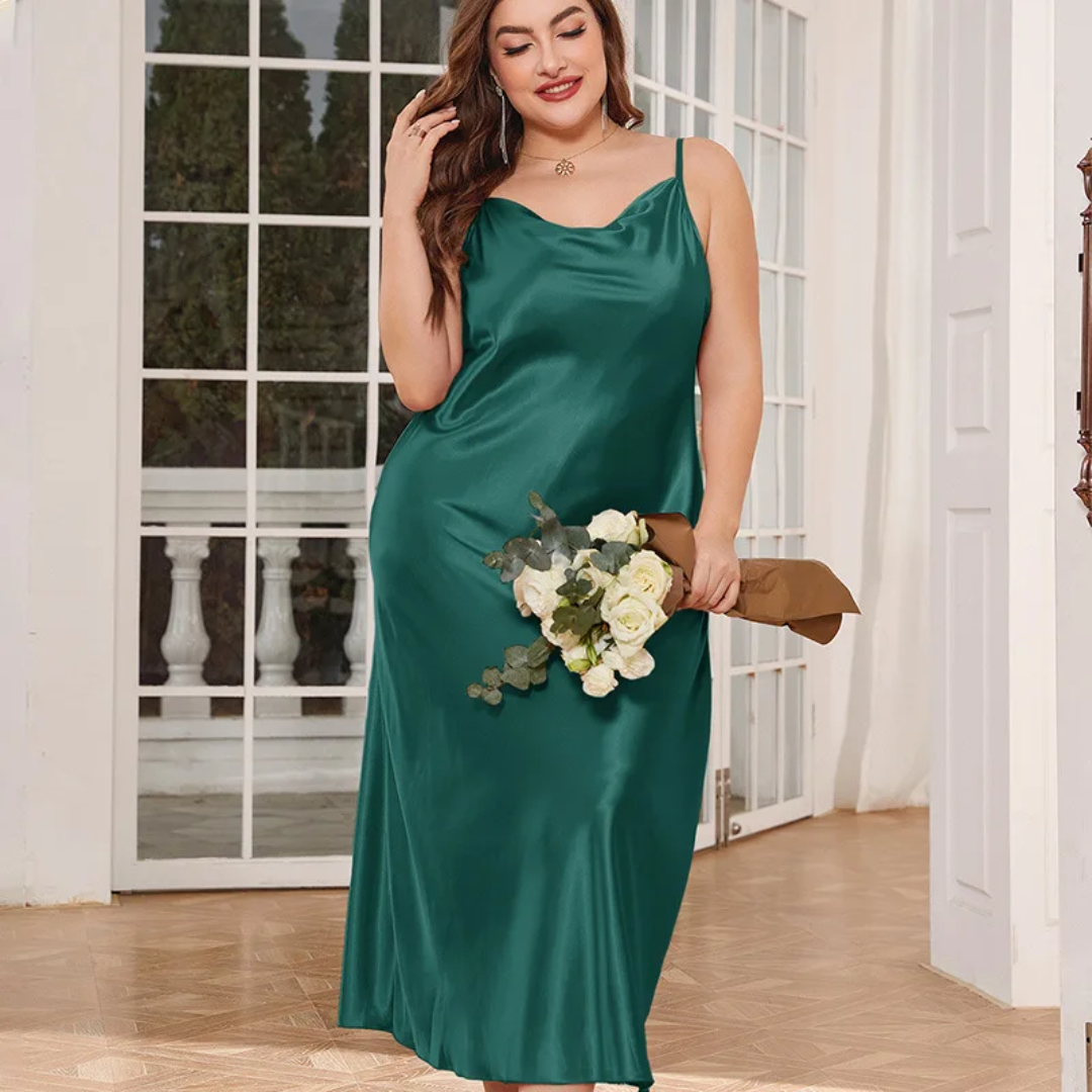 a woman in a green dress holding a bouquet of flowers