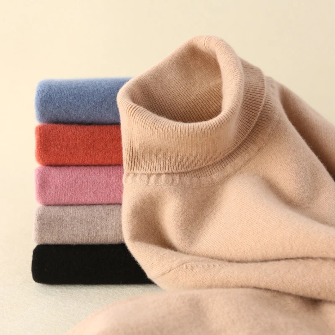 a pile of folded sweaters sitting on top of a table