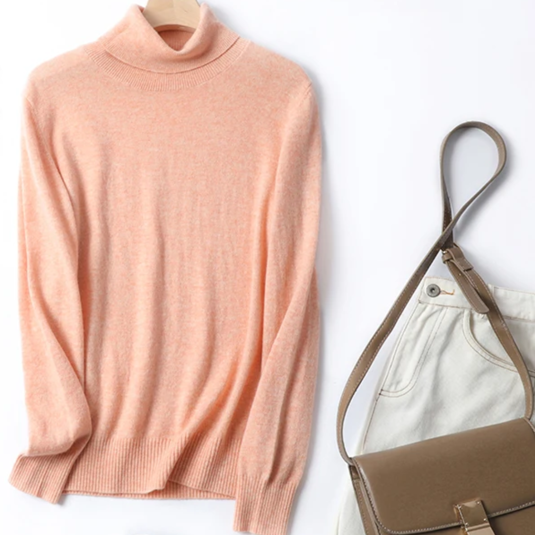 a sweater and a handbag sitting next to each other