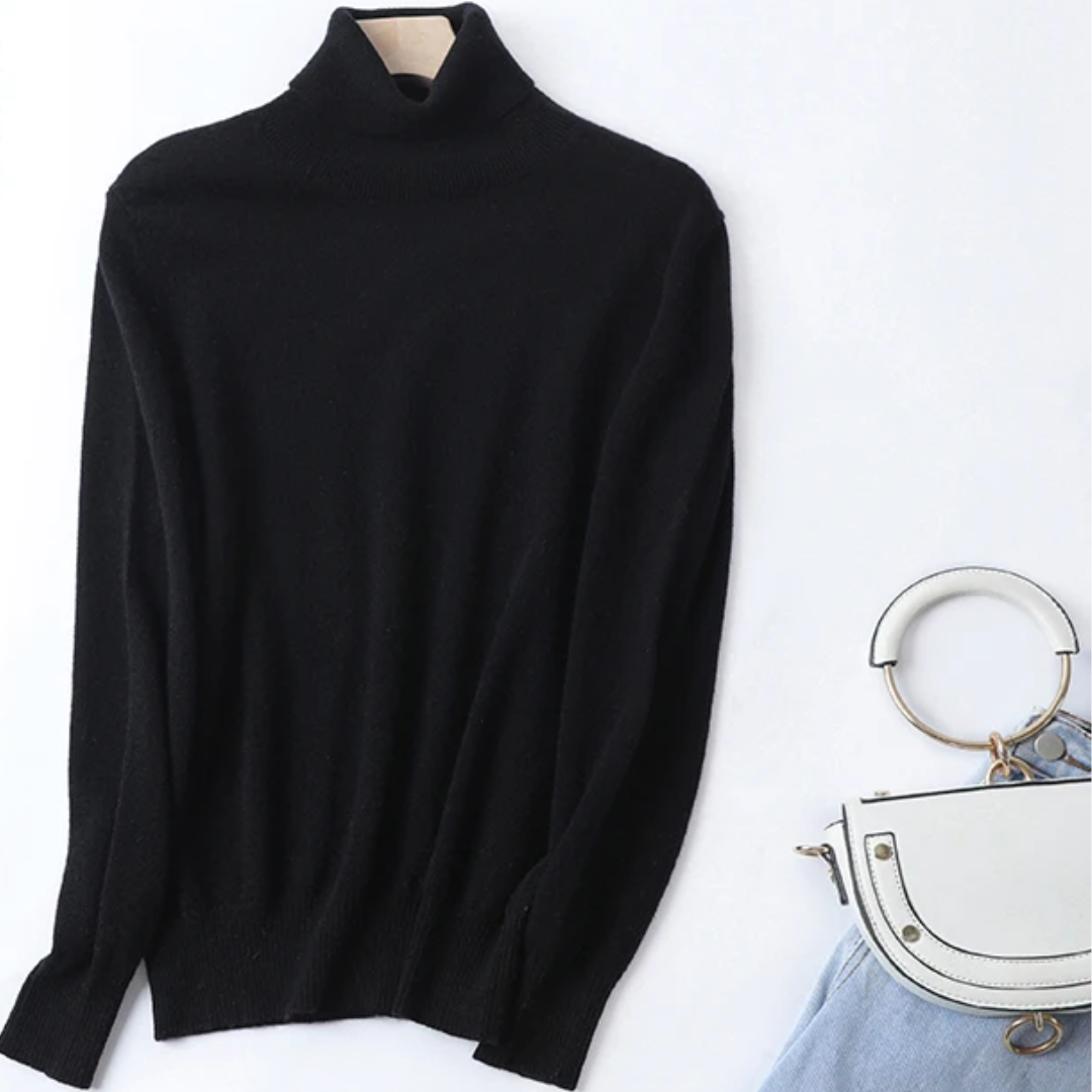 a black turtle neck sweater next to a purse