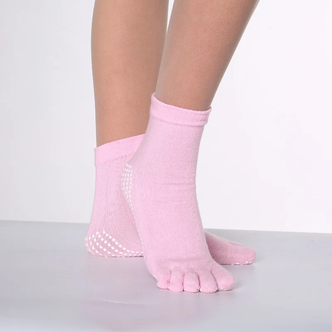 a woman's feet with pink socks and polka dots