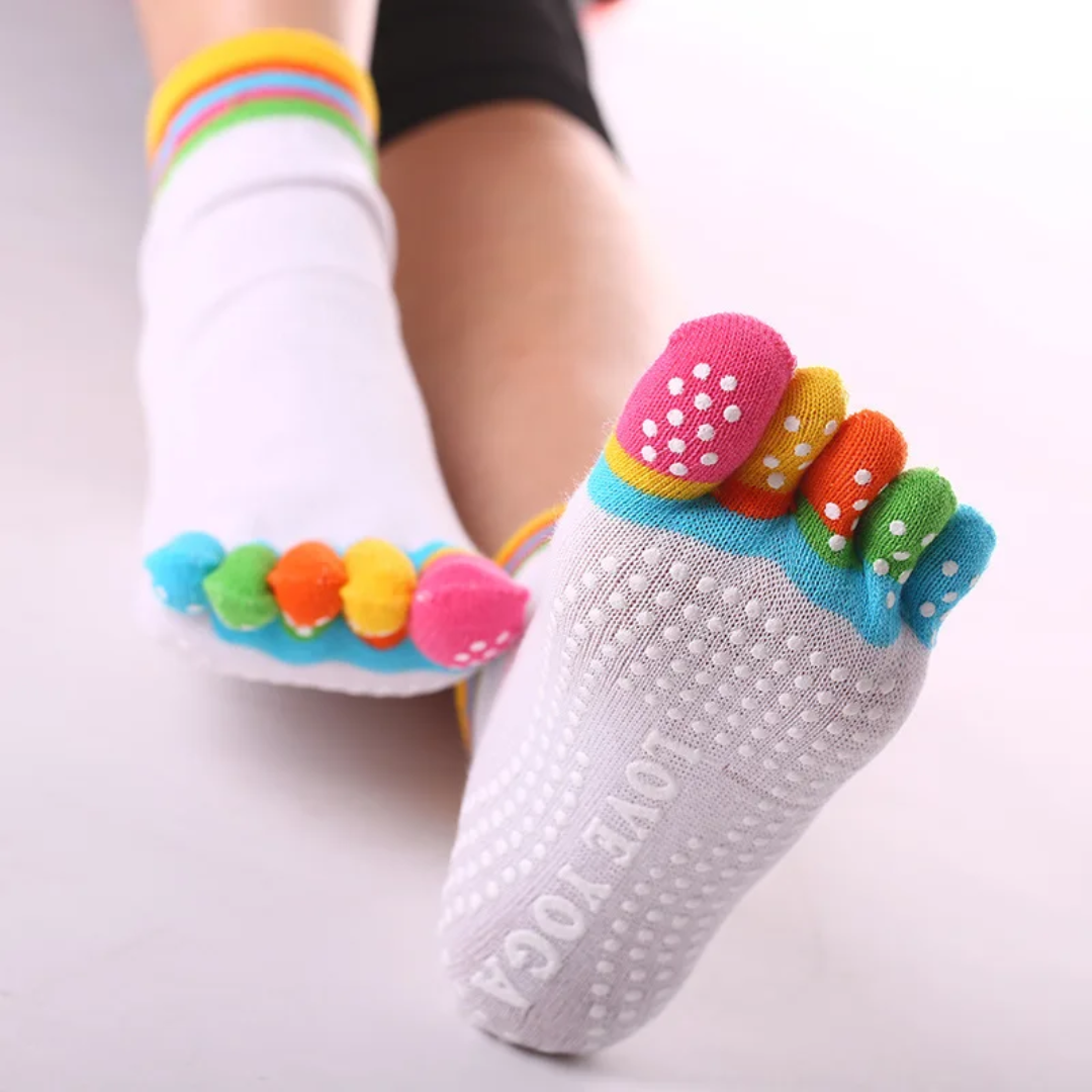 a close up of a person's feet wearing colorful socks